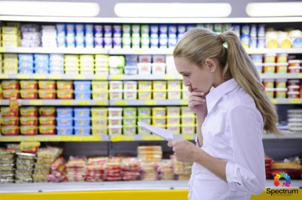 woman going over list in grocery store