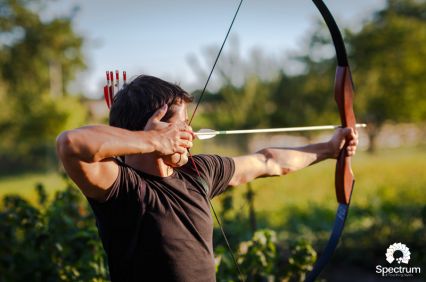 male shooting bow and arrow